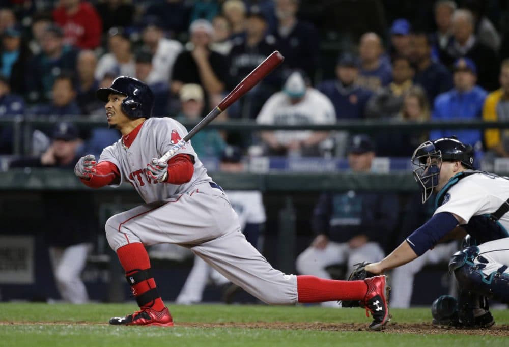 Boston Red Sox's Mookie Betts hits a sacrifice fly that allowed him to reach first base on a fielding error by Seattle Mariners left fielder Rickie Weeks in the ninth inning of a baseball game, Thursday, May 14, 2015, in Seattle. (Ted S. Warren/AP)