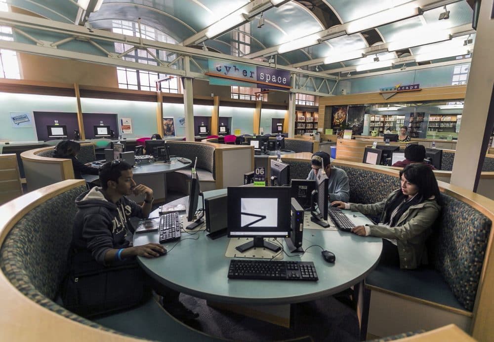 Patrons use computers in the Teen'Scape area at the Los Angeles Public Library. (Damian Dovarganes/AP)