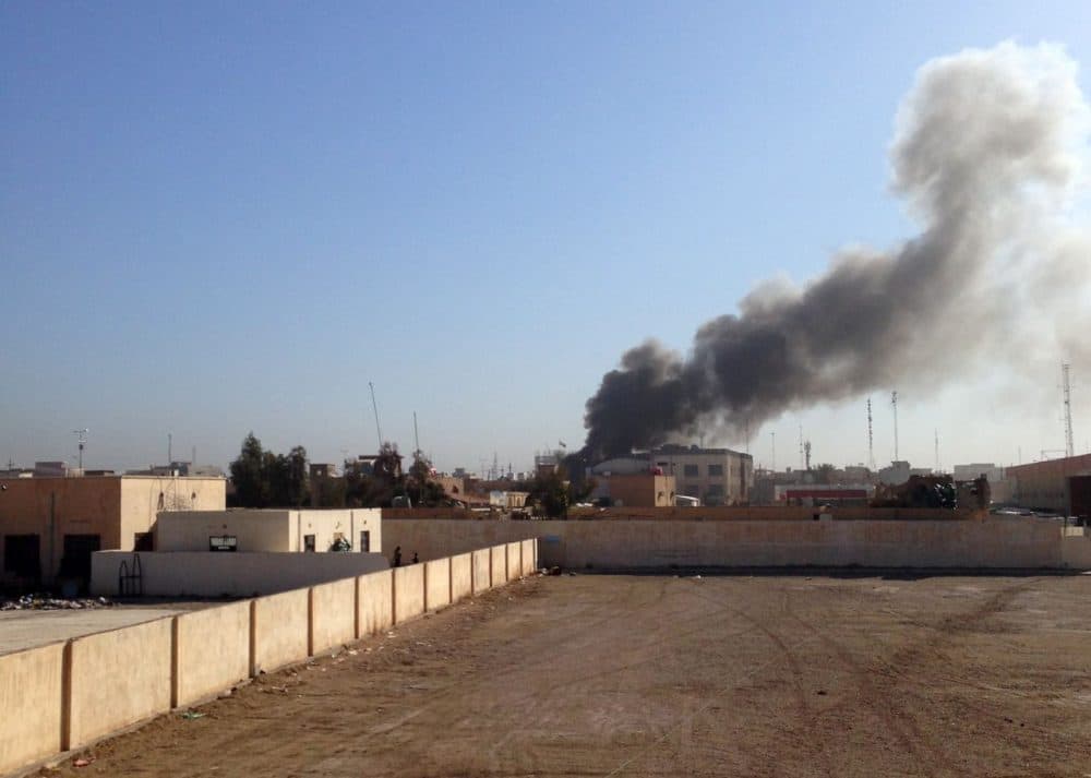 A picture taken on March 11, 2015 shows smoke billowing after the building of the Anbar Governorate was hit by a mortar shell in the Hosh district of Ramadi as the Islamic State jihadist group launched a coordinated attack on government-held areas of the western Iraqi city, involving seven almost simultaneous suicide car bombs, police said. (Azhar Shallal/AFP/Getty Images)