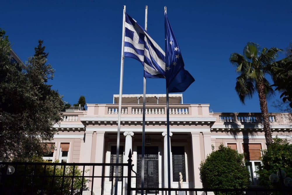 Greek and E.U. flags flutter in front of the prime minister's office in Athens during his meeting with top ministers on May 13, 2015. (Louisa Gouliamaki/AFP/Getty Images)