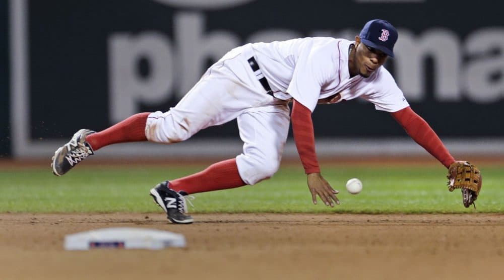 Red Sox shortstop Xander Bogaerts tries unsuccessfully to make a play on a single by Texas Rangers' Adam Rosales in the eighth inning of a game at Fenway, Thursday, May 21, 2015. (Charles Krupa/AP)