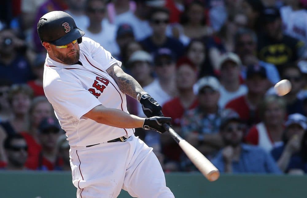 Boston Red Sox's Mike Napoli hits a two-run double during the eighth inning of a game against the Los Angeles Angels Sunday. (Michael Dwyer/AP)