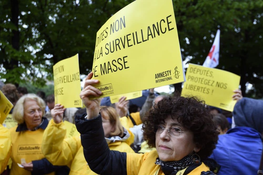 Protesters hold placards reading 'Say no to mass surveillance' take part on May 4, 2015 in Paris in a demonstration against the government's controversial bill giving spies sweeping new surveillance powers, deemed 'heavily intrusive' by critics. (Alain Jocard/AFP/Getty Images)