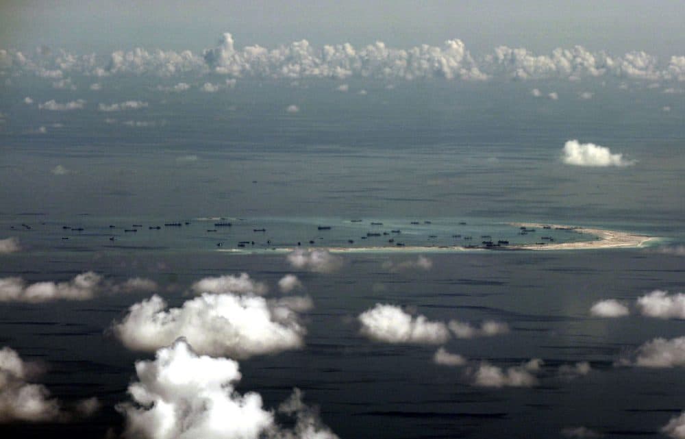 This areal photo taken through a glass window of a military plane shows China's alleged on-going reclamation of Mischief Reef in the Spratly Islands in the South China Sea Monday, May 11, 2015. (Ritchie B. Tongo/AP)