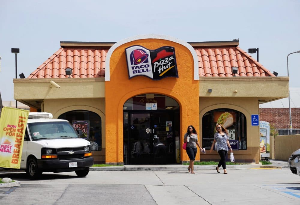 Customers walk out of a Taco Bell and Pizza Hut restaurant during lunchtime on April 19, 2012 in Los Angeles, California. (Kevork Djansezian/Getty Images)