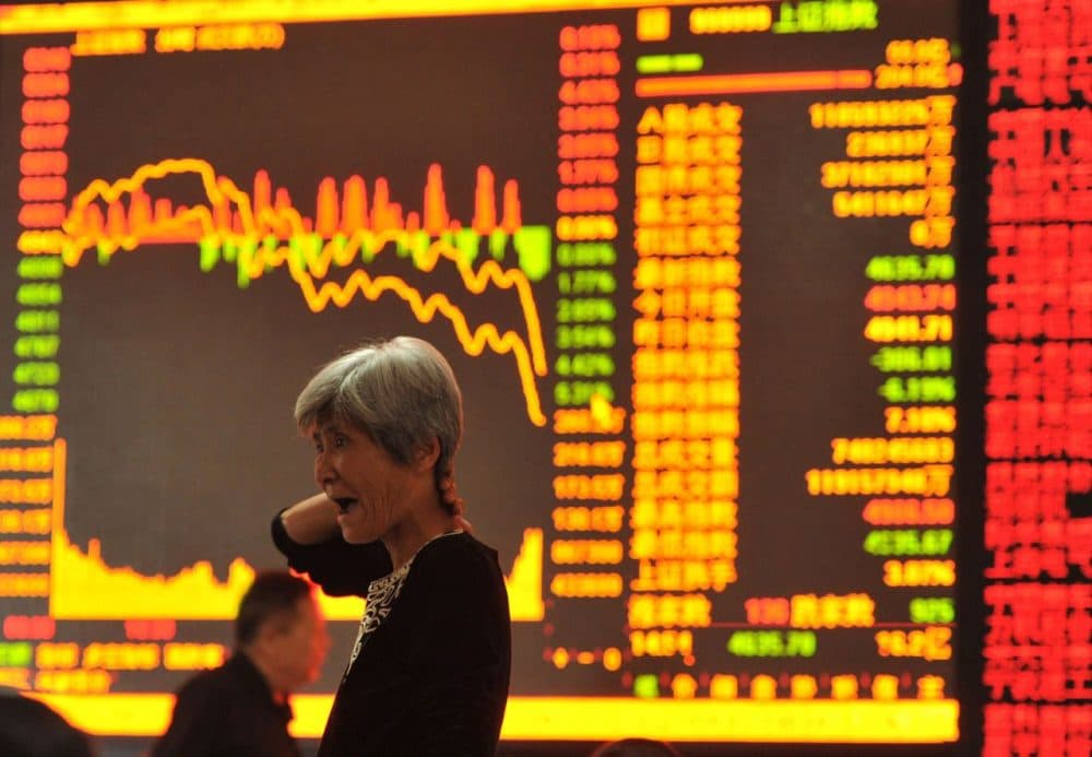 A stock investor gestures as she checks share prices at a security firm in Fuyang, east China's Anhui province on May 28, 2015. Chinese stocks plunged 6.5 percent on May 28 on concerns over tight liquidity and stricter requirements for margin trading, after closing at a more than seven-year high the previous day, dealers said. (STR/AFP/Getty Images)