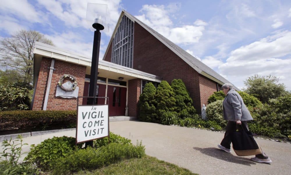 Barbara Nappa, of Scituate, Mass., heads into the St. Frances Xavier Cabrini Church to take her turn sitting vigil in Scituate, Mass. (Charles Krupa/AP)