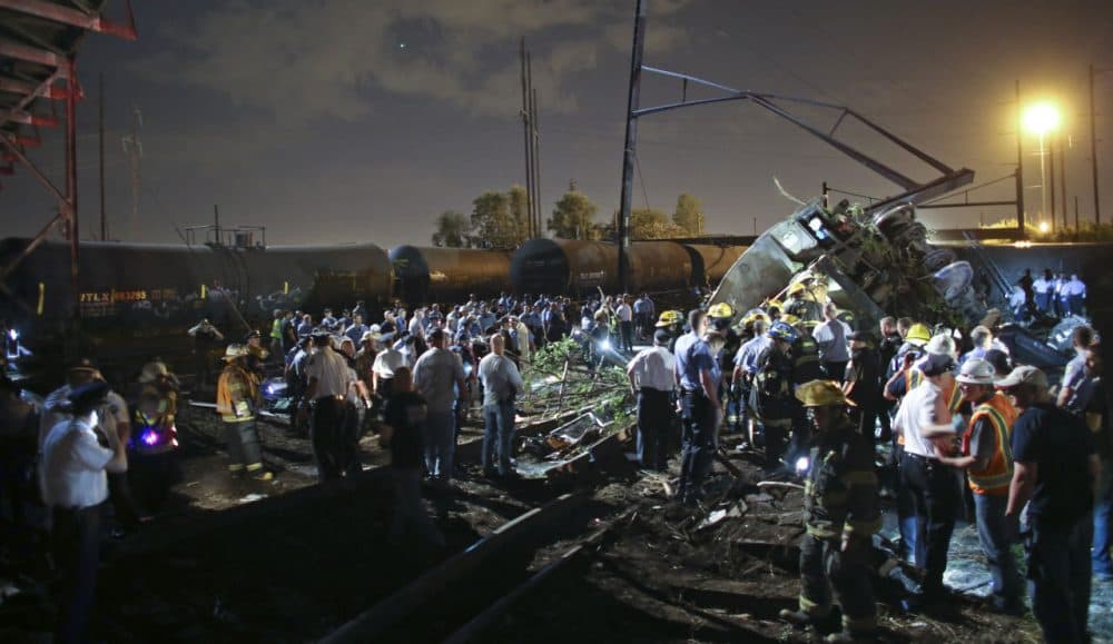 The train hurtled off the tracks while rounding a sharp curve in an old industrial neighborhood not far from the Delaware River shortly after 9 p.m. (Joseph Kaczmarek/AP)