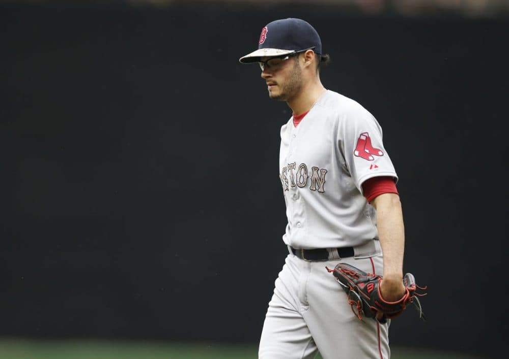 Red Sox pitcher Joe Kelly leaves in the second inning of the game after giving up seven runs to the Twins. (Jim Mone/AP)