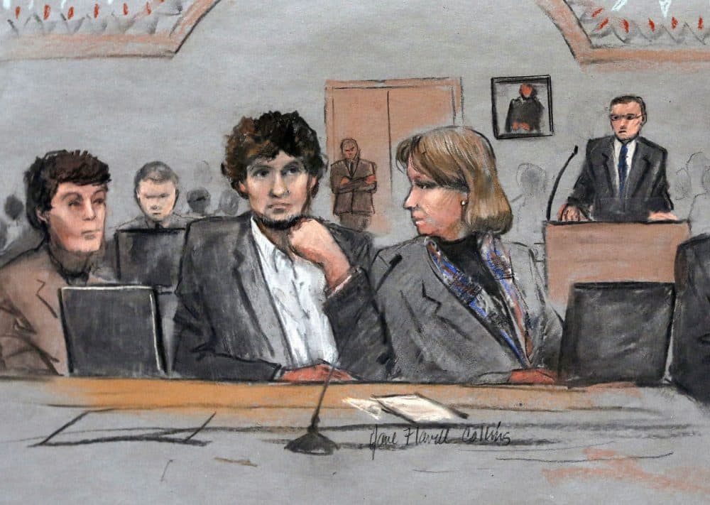 In this courtroom sketch, Dzhokhar Tsarnaev, center, is depicted between defense attorneys Miriam Conrad, left, and Judy Clarke, right, during his federal death penalty trial in Boston. Clarke delivered the closing arguments for the defense today. (Jane Flavell Collins via AP)