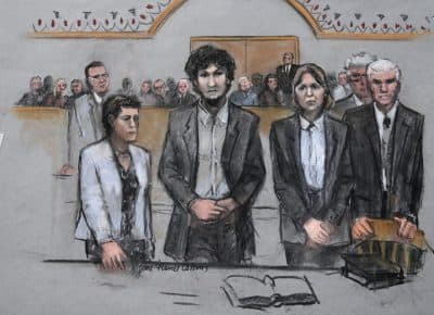 In this courtroom sketch, Boston Marathon bomber Dzhokhar Tsarnaev stands with his defense attorneys as a death sentence is read at the Moakley courthouse in Boston on May 15. The federal jury ruled that the 21-year-old Tsarnaev should be sentenced to death for his role in the deadly 2013 attack. (Jane Flavell Collins via AP)