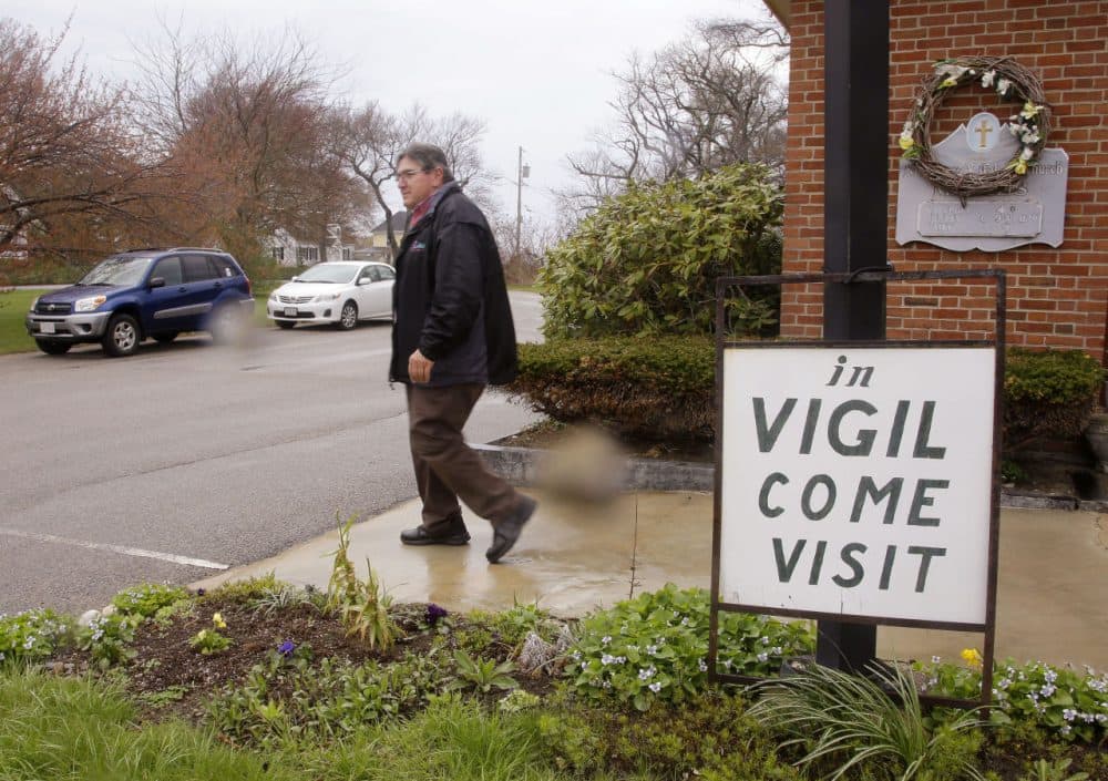 A parishioner who has been in vigil at St. Frances Xavier Cabrini Church for the past five years, leaves after his shift is over. (Stephan Savoia/AP)