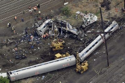 Emergency personnel work at the scene of a deadly train derailment, Wednesday, May 13, 2015, in Philadelphia. The Amtrak train, headed to New York City, derailed and crashed in Philadelphia on Tuesday night, killing at least six people and injuring dozens of others.  (AP)