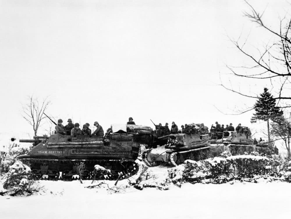American tanks and armored gun carriers drive over snow-covered terrain towards Samree, Belgium Dec. 1944. (Fred Ramage/AP)