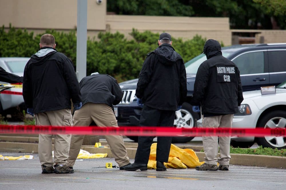 Authorities examine evidence at the scene of a fatal shooting Tuesday morning in Boston. (Jesse Costa/WBUR)