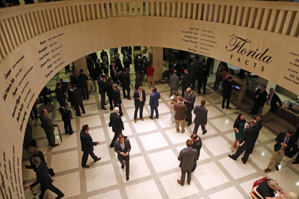 Lobbyists work in the rotunda between the Florida House and Senate chambers during session, Tuesday, April 28, 2015, at the Capitol in Tallahassee, Fla. The Florida House adjourned its annual session three days early because of a budget impasse with the Senate over Medicaid expansion. (Steve Cannon/AP)