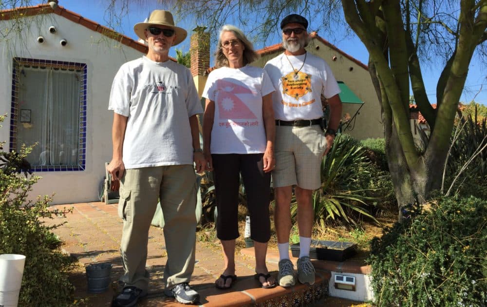 Transition Streets San Diego members Gawain Thompson, and Leslie and Jamie Edmonds stand in front of the Edmonds' home in El Cerrito, California. (Robin Young/Here &amp; Now)