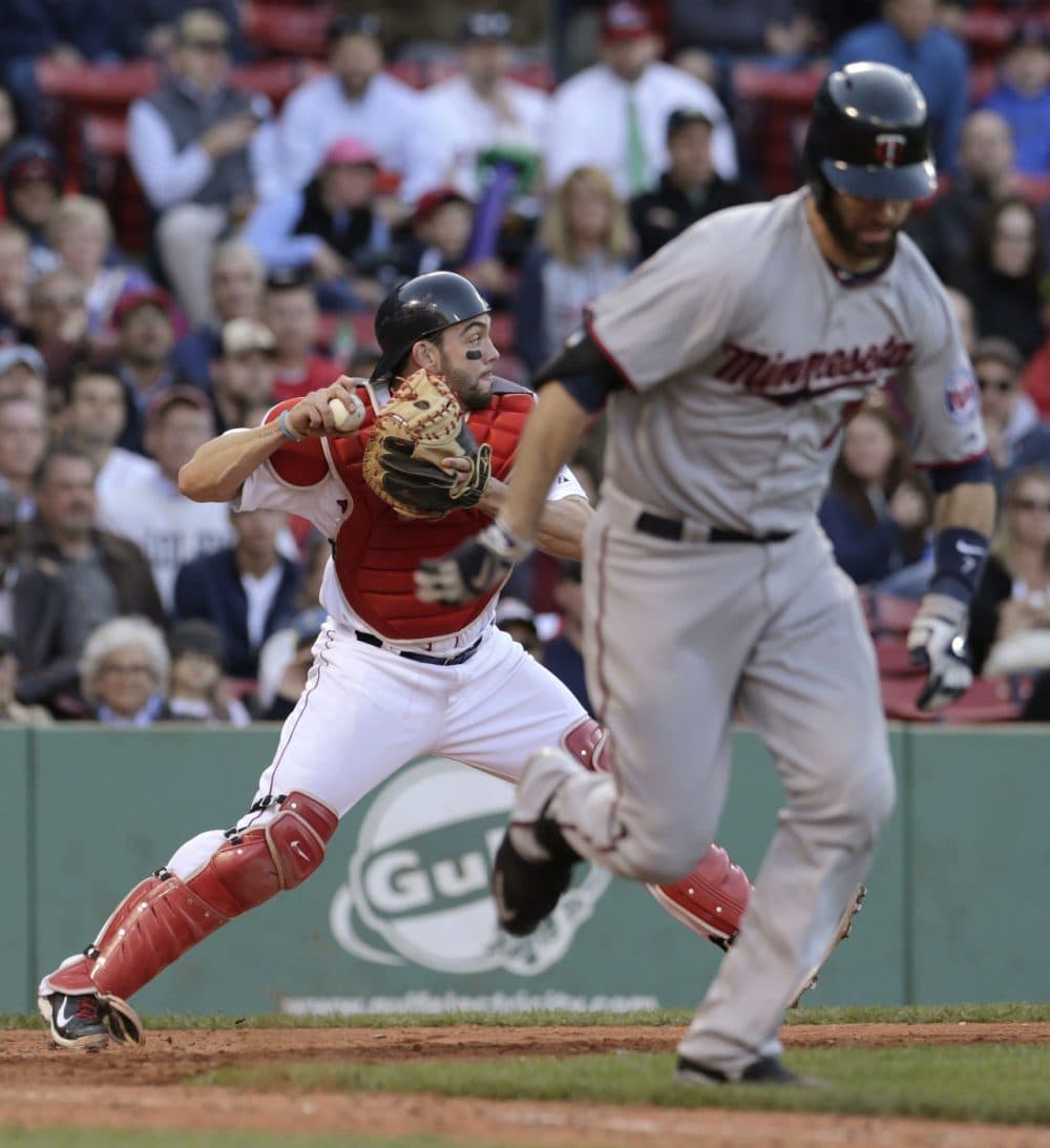 Boston Red Sox catcher Blake Swihart, left, throws to third baseman Pablo Sandoval after a bunt by Minnesota Twins' Joe Mauer during the ninth inning of a game at Fenway on Thursday, June 4, 2015, in Boston.  (Charles Krupa/AP)