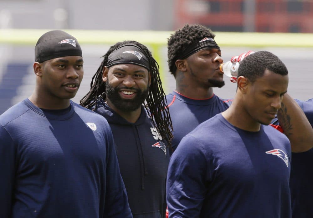 New England Patriots linebacker Brandon Spikes (second from left) smiles after an organized team activity on June 4. (Stephan Savoia/AP)