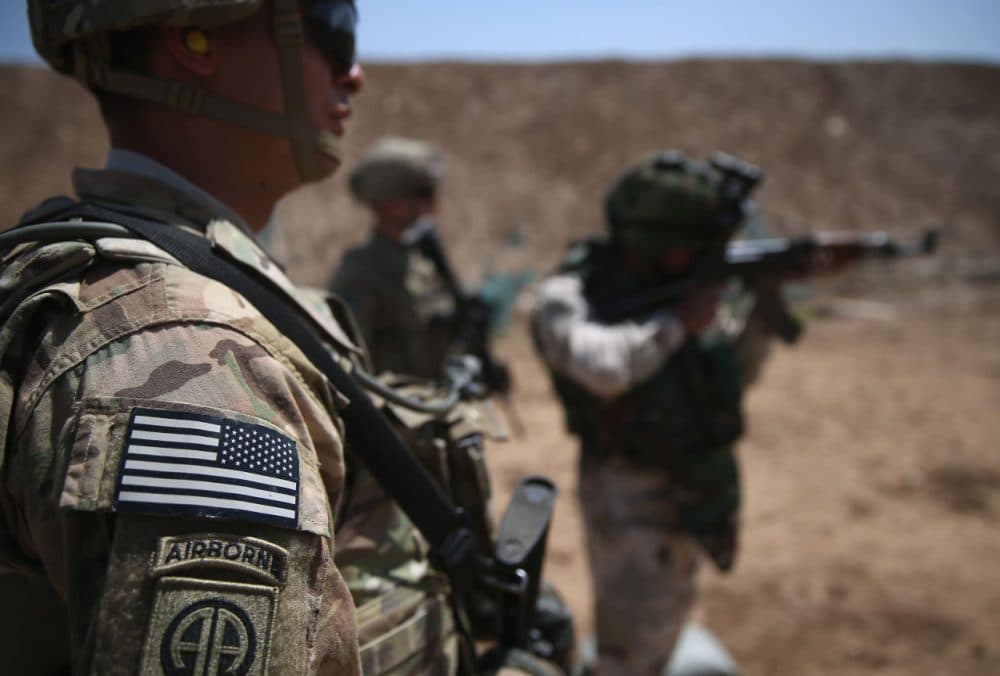 U.S. Army trainers watch as an Iraqi recruit fires at a military base on April 12, 2015 in Taji, Iraq. U.S. forces, currently operating in 5 large bases throughout the country, are training thousands of Iraqi Army combat troops, trying to rebuild a force they had originally trained before the U.S. withdrawal from Iraq in 2010. Members of the U.S. Army's 5-73 CAV, 3BCT, 82nd Airborne Division are teaching members of the newly-formed 15th Division of the Iraqi Army, as the Iraqi government launches offensives to try to recover territory lost to ISIS last year. (John Moore/Getty Images)