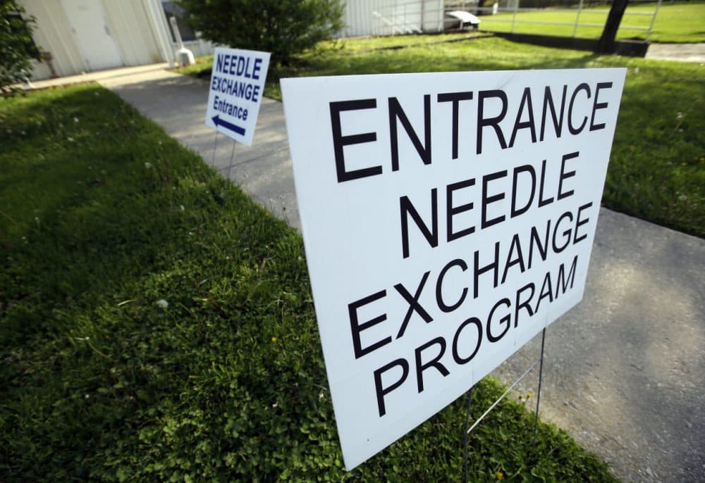 Signs are displayed for the needle exchange program at the Austin Community Outreach Center in Austin, Indiana, on April 21, 2015. A genetic analysis of HIV samples taken from about half the people infected in the largest HIV outbreak in Indiana history shows nearly all of them have the same strain of the virus, a finding one health expert says is a sobering reminder of how rapidly HIV can spread among intravenous drug users. (Darron Cummings/AP)