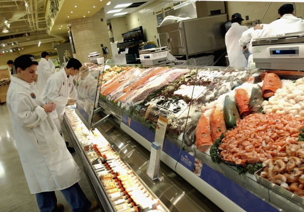 Clerks prepare the fish selling department at Whole Foods Market in New York City.  (Stephen Chernin/Getty Images)