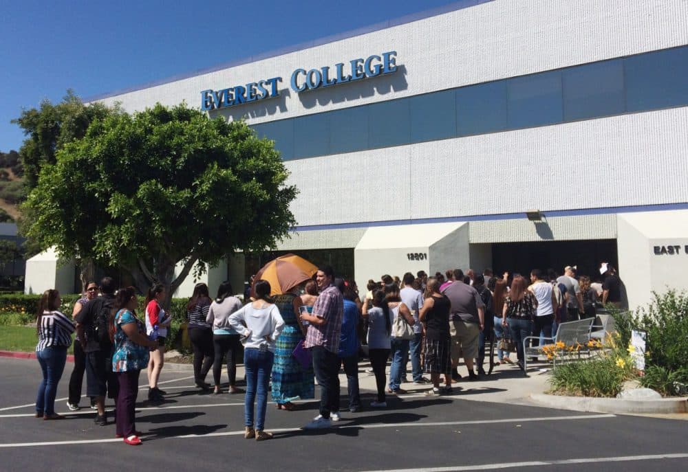 Students wait outside Everest College, owned by Corinthian Colleges Inc., Tuesday, April, 28, 2015 in Industry, Calif., hoping to get their transcriptions and information on loan forgiveness and transferring credits to other schools. (Christine Armario/AP)