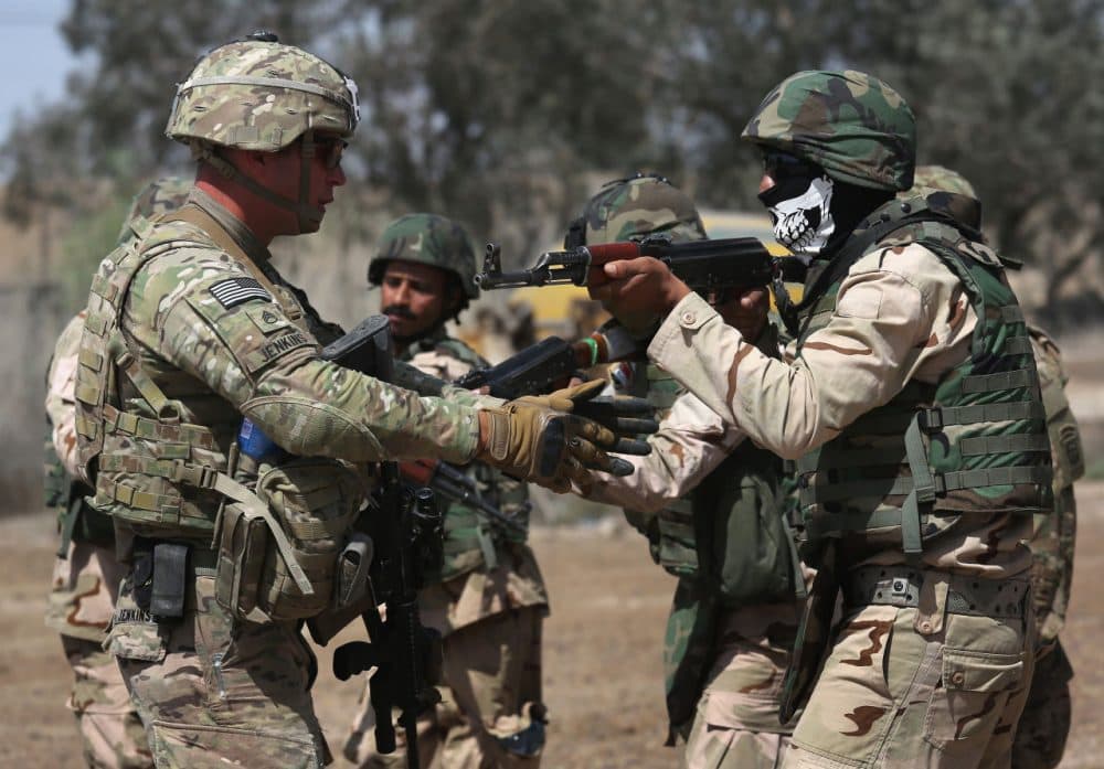A U.S. Army trainer (L), instructs Iraqi Army recruits at a military base on April 12, 2015 in Taji, Iraq. Members of the U.S. Army's 5-73 CAV, 3BCT, 82nd Airborne Division are teaching members of the newly-formed 15th Division of the Iraqi Army, as the Iraqi government launches offensives to try to recover territory lost to ISIS last year. (John Moore/Getty Images)