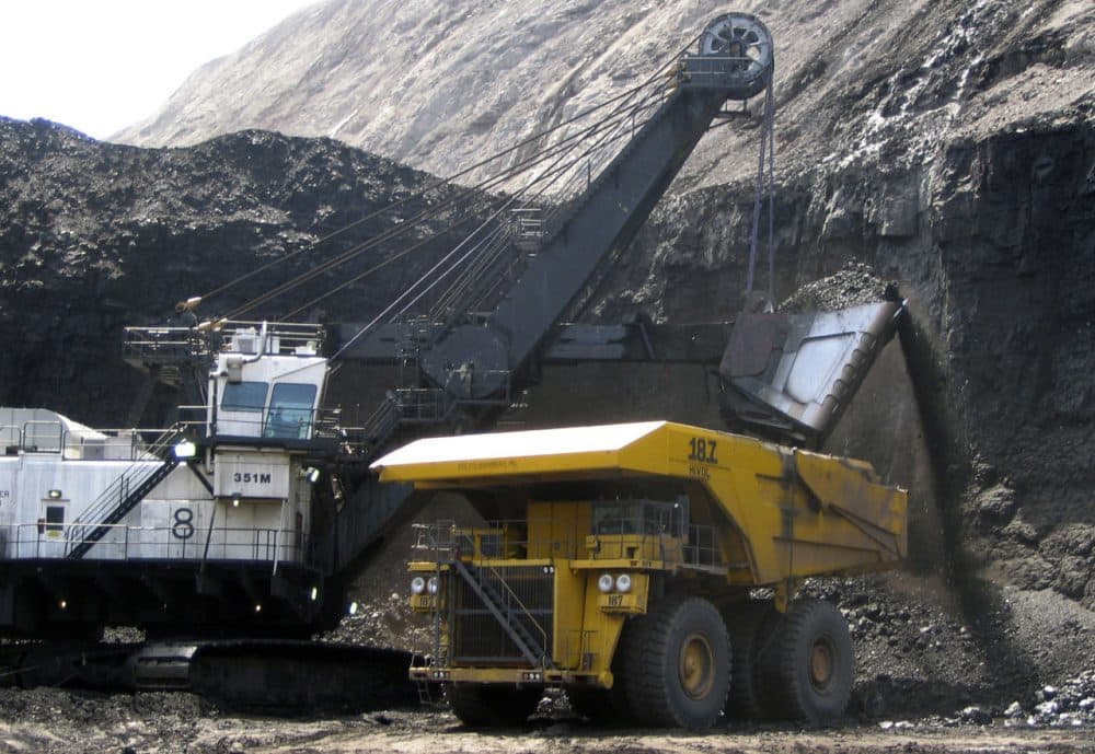 A shovel prepares to dump a load of coal into a 320-ton truck at the Black Thunder Mine in Wright, Wyo., in April, 2007. (Matthew Brown/AP)