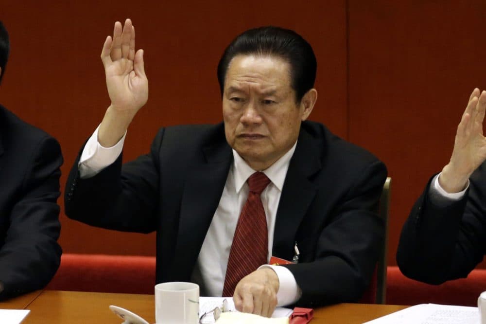 Zhou Yongkang, the then Chinese Communist Party Politburo Standing Committee member in charge of security, raises his hand to show approval for a work report during the closing ceremony for the 18th Communist Party Congress at the Great Hall of the People in Beijing, China on Nov. 14, 2012. (Lee Jin-man/AP)