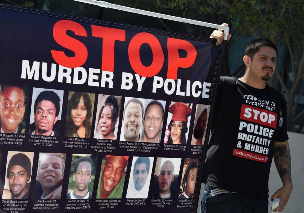 Members of Stop Mass Incarceration Network and other civil rights advocates protest outside LAPD headquarters after a homeless man known as 'Africa' was controversially shot dead by police in Los Angeles, California on March 7, 2015. (Mark Ralston/AFP/Getty Images)