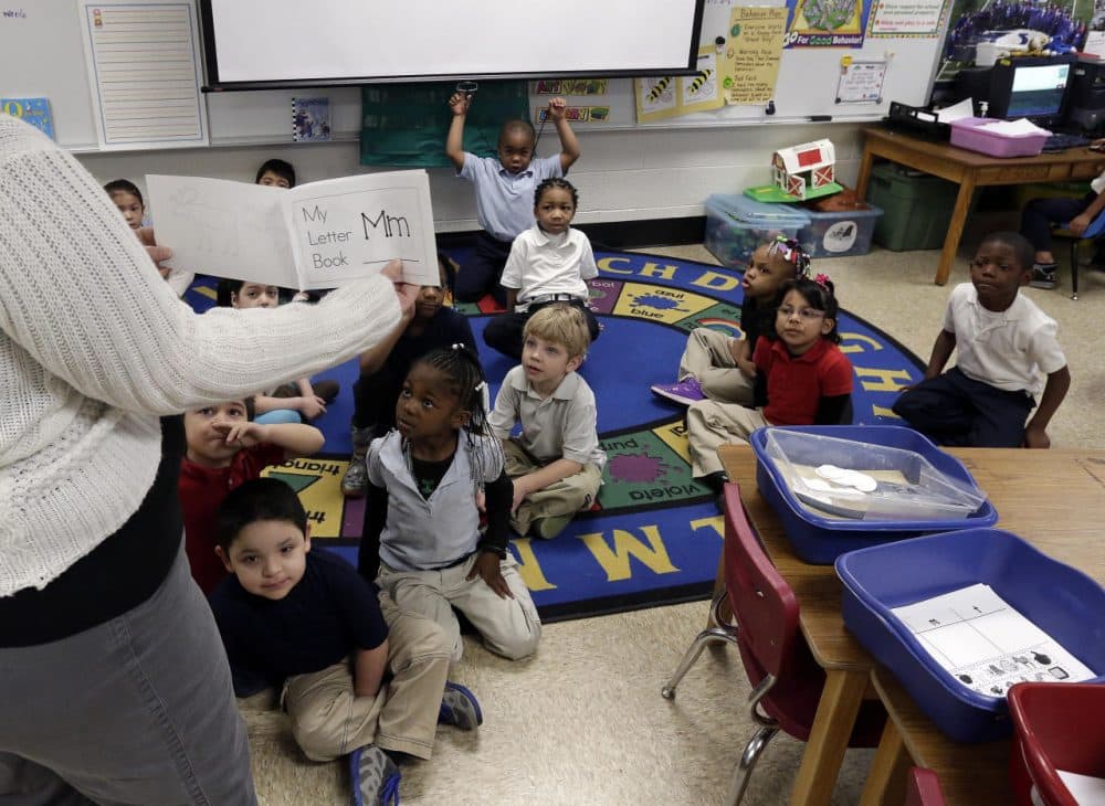 Kindergarten students listen as their teacher explains the day's activities to them at George Buck Elementary School in Indianapolis. (AJ Mast/AP)