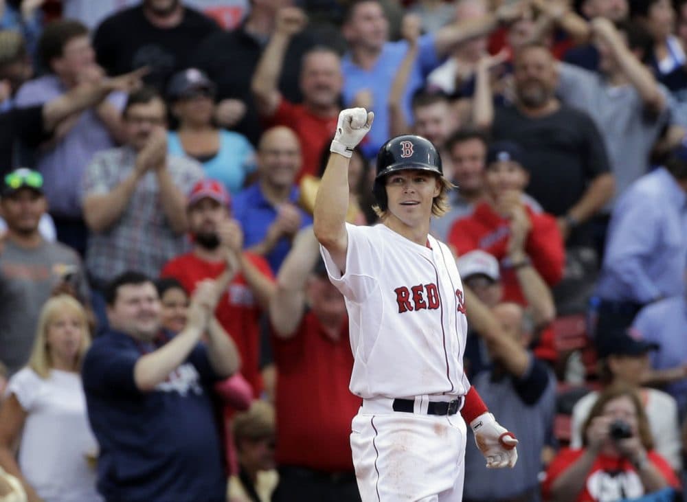 Boston Red Sox's Brock Holt gestures after hitting a triple in the eighth inning of the game against the Atlanta Braves at Fenway Park Tuesday, June 16, 2015. Holt hit for the cycle, the first Sox player to do so in 19 years.  (Elise Amendola/AP)