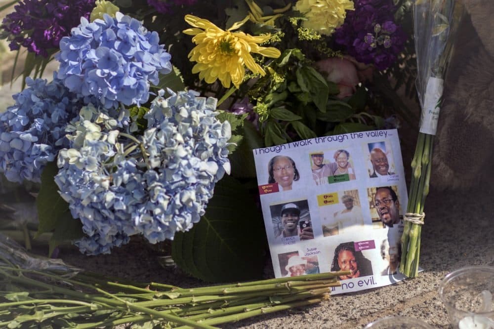 Flowers and notes of hope and support from the community line the sidewalk Friday in front of the Emanuel AME Church in Charleston, S.C. Dylann Storm Roof, 21, is accused of killing nine people during a Wednesday night Bible study at the church.  (Stephen B. Morton/AP)
