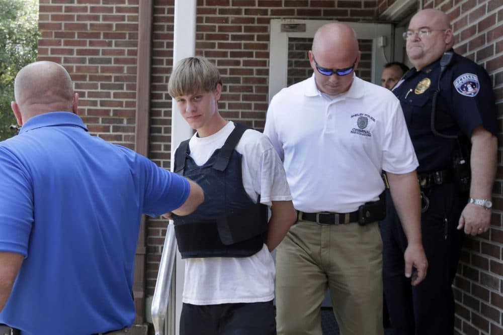 Charleston, S.C., shooting suspect Dylann Storm Roof, center, is escorted from the Shelby Police Department in Shelby, N.C., Thursday, June 18, 2015. Roof is a suspect in the shooting of several people Wednesday night at the historic The Emanuel African Methodist Episcopal Church in Charleston, S.C. (Chuck Burton/AP)