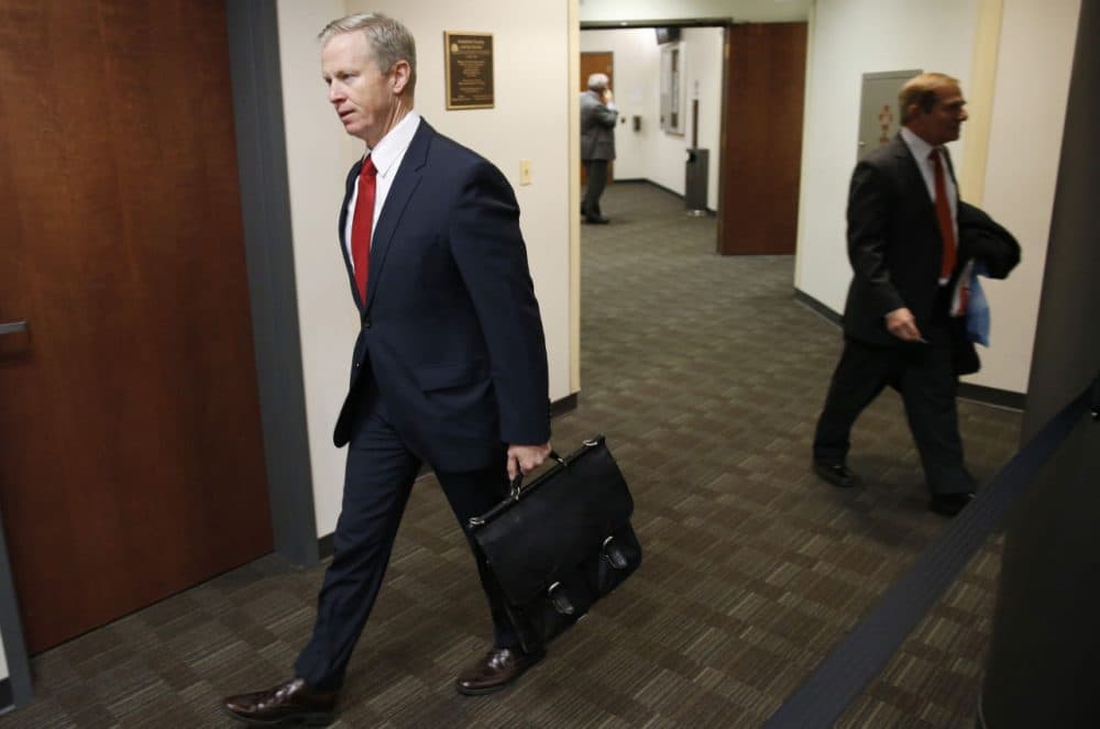 George Brauchler, left, district attorney of Arapahoe County, Colo., walks to a hearing in Centennial, Colo., in the murder trial of Aurora movie theater shooter James Holmes. (David Zalubowski/AP)