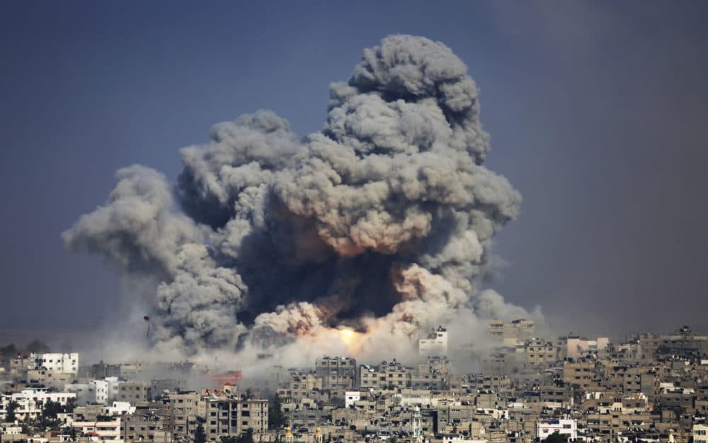 In this July 29, 2014 file photo, smoke and fire from an Israeli strike rise over Gaza City. (Hatem Moussa/AP)