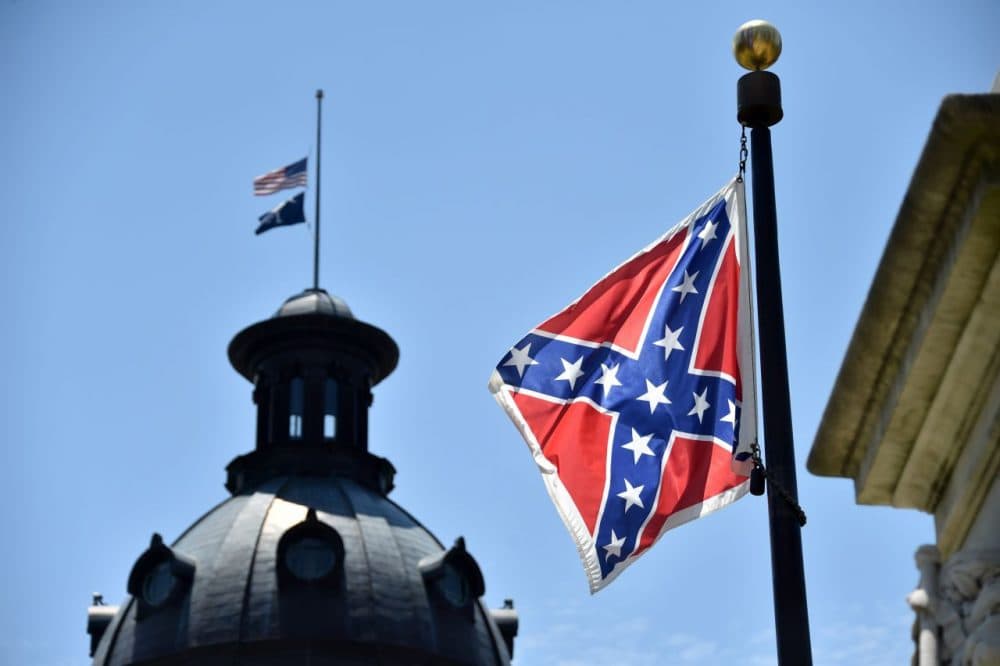 The South Carolina and American flags fly at half-staff behind the Confederate flag, in front of the State House in Columbia, South Carolina on June 19, 2015. (Mladen Antonov/AFP/Getty Images)