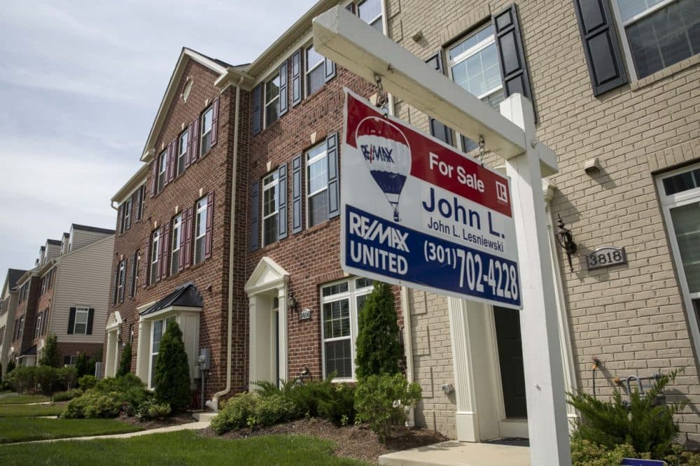 A 'For Sale' sign sits in the front yard of a townhouse June 23, 2015 in Northeast Washington, D.C. Purchases of new homes in the U.S. rose in May to the highest level in seven years, signaling that the industry may be gaining momentum heading toward the second half of the year. (Drew Angerer/Getty Images)