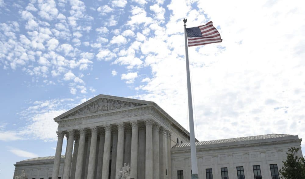The flag flies in the wind in front of the Supreme Court in Washington, Monday, June 22, 2015. (Susan Walsh/AP)