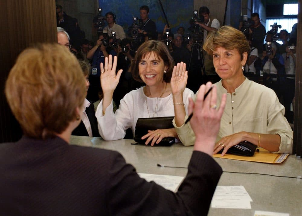 Hillary, right, and Julie Goodridge, left, lead plaintiffs in the Massachusetts gay marriage lawsuit, raise their right hands and affirm that everything on their marriage license is correct while at Boston City Hall in Boston in this Monday May 17, 2004 photo. (Charles Krupa/AP)