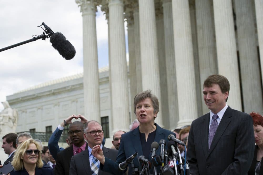 Civil rights lawyer Mary Bonauto, center, flanked by plaintiff James Obergefell of Ohio, left, and Washington attorney Douglas Hallward-Driemeier, right, speaks outside the Supreme Court in Washington, Tuesday , April 28, 2015, following a hearing on same-sex marriage. (Cliff Owen/AP)