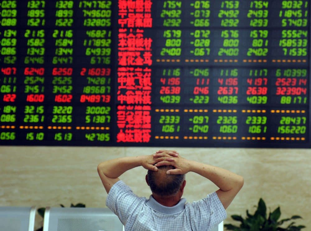 A Chinese stock investor monitors share prices at a securities firm in Fuyang, in China's Anhui province on June 19, 2015.  Shanghai shares plunged 6.42 percent on June 19, ending a torrid week as the benchmark index was hit by tight liquidity and profit-taking after a powerful surge over the past year.    (STR/AFP/Getty Images)