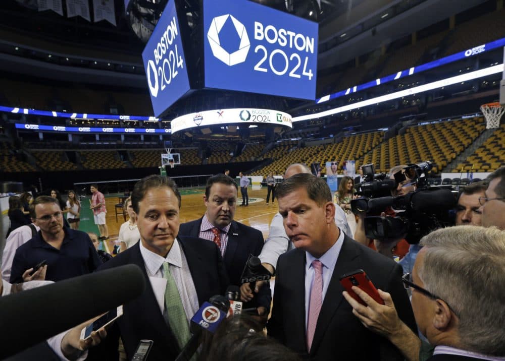 Boston 2024 Chairman Steve Pagliuca, foreground left, and Boston Mayor Marty Walsh, right, speak to reporters Thursday at TD Garden. (Elise Amendola/AP)
