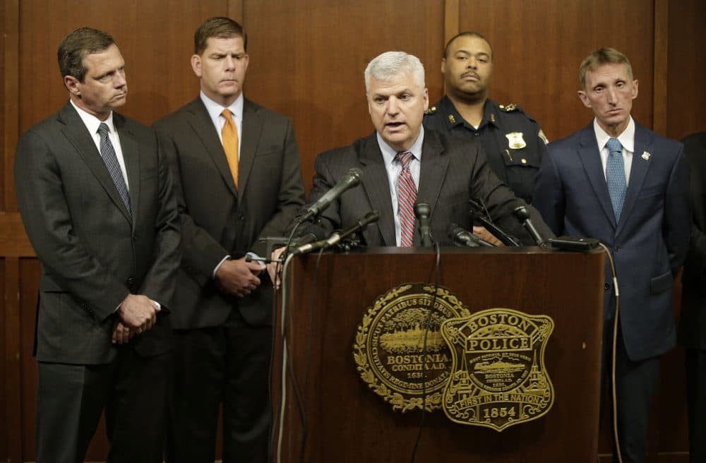 Suffolk County District Attorney Daniel F. Conley speaks as FBI Special Agent in Charge of Boston Vincent B. Lisi, left to right, Boston Mayor Marty Walsh and Boston Police Commissioner William B. Evans, far right, look on during a joint news conference at the Boston Police Department's Headquarters Tuesday, June 2, 2015, in Boston. A man under surveillance by a joint terrorism task force was shot and killed outside a pharmacy Tuesday after he lunged with a knife at a city police officer when asked to drop his military style knife before the officer and an FBI agent opened fire. (AP Photo/Stephan Savoia)