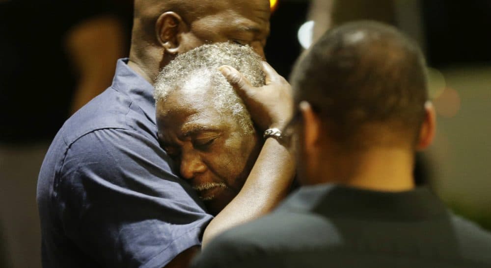 Worshippers embrace following a group prayer across the street from the scene of a shooting at Emanuel AME Church, Wednesday, June 17, 2015, in Charleston, S.C. (David Goldman/AP)