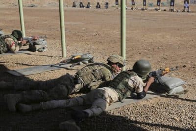 In this file photo, A U.S. soldier trains an Iraqi security forces member in a shooting drill in Taji, north of Baghdad, Iraq, Saturday, March 21, 2015.  (AP)