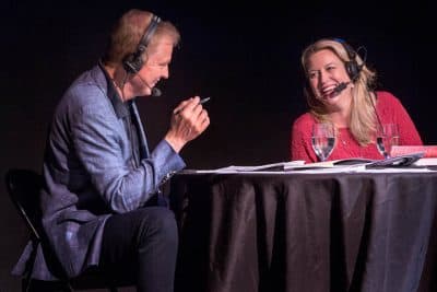 On Point host Tom Ashbrook shares a laugh with author and advice columnist Cheryl Strayed at the 2015 iteration of On Point LIVE at the Paramount Theatre in Boston. (Robin Lubbock / WBUR)
