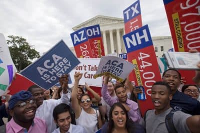 Students cheer as they hold up signs stating that numbers of people in different states who would lose healthcare coverage, with the words &quot;lose healthcare&quot; now over written with &quot;still covered&quot; stickers, after the Supreme Court decided that the without the Affordable Care Act (ACA) may provide nationwide tax subsidies, Thursday June 25, 2015, outside of the Supreme Court in Washington.  (AP)