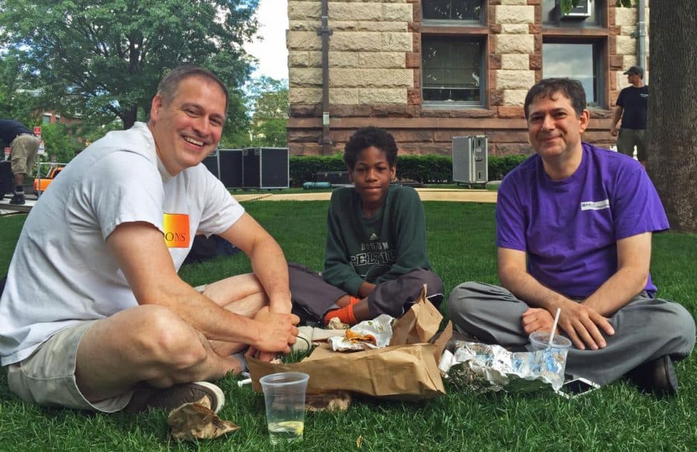 Don Picard and Robert DeBenedictis eat lunch with their son James on the lawn by Cambridge City Hall Friday. It was here back in 2004 that Picard and DeBenedictis were among the first gay couples granted marriage licenses in Massachusetts. (Curt Nickisch/WBUR)